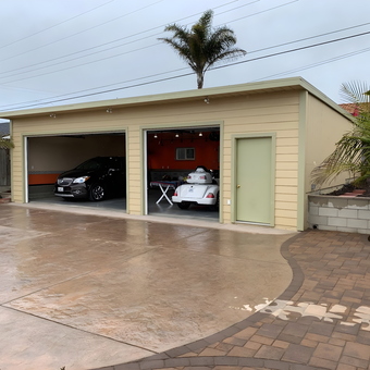 Two-car garage with modern vehicles and workspace - Cave man from Grover Beach, CA