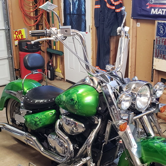 Green custom motorcycle on lift in organized garage - Camaro boy from Parowan, UT