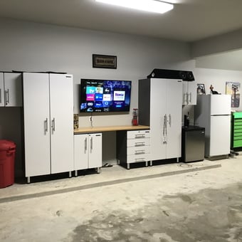 Modern Garage with White Cabinets, Tool Chest, and Fridge - Anonymous