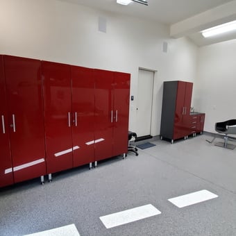 Modern Garage With Red Storage Cabinets and Chair - Anonymous