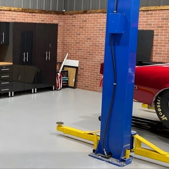 Modern Garage With Black Cabinets and Car Lift - Anonymous