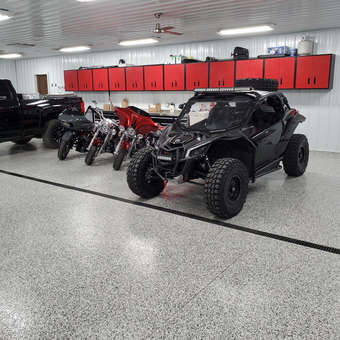Organized garage with red cabinets and vehicles - Troy from REDWOOD FALLS, MN