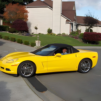 Yellow Corvette Convertible Parked in Residential Driveway