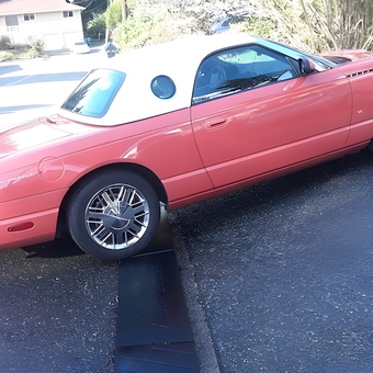Convertible Car on Driveway with Curb Ramp and Chrome Wheels