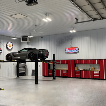 Modern Garage With Car Lift and Red Cabinets - Mike