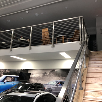 Modern garage with loft, metal railing, and cars - Swan from Napervy, IL