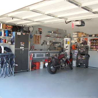 Organized garage with shelves, cabinets, and motorcycle - Orly Toro from Fort Worth, TX