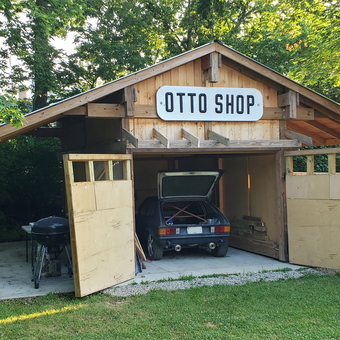 Wooden garage with car, grill, and Otto Shop sign - Otto from Westerville, OH