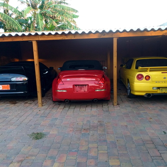 Three Sports Cars Parked Under Wooden Carport - ArubaDave from Doral, FL