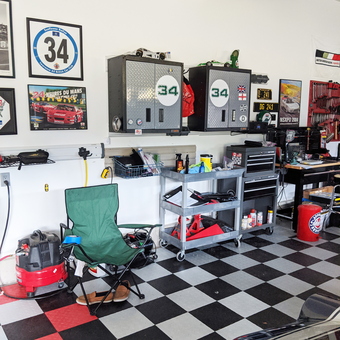 Organized garage with wall cabinets, tool cart, and checkered floor - Rich from Kittery, ME
