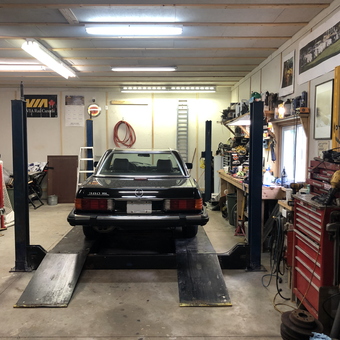 Organized garage with car lift, tool chests, and workbench - Frozenbon from Ottawa Canada