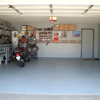 Organized garage with motorcycle, cabinets, and tool chests - Orly Toro from Fort Worth, TX