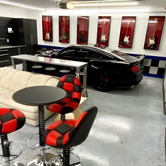 Modern Garage with Black Cabinets and Red Bar Stools - Bruce