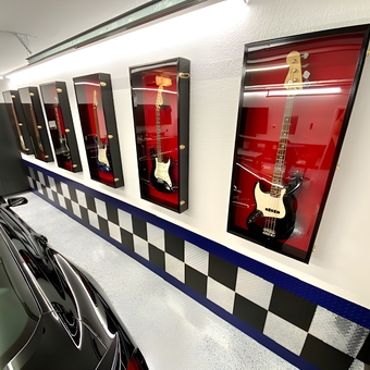 Garage with Guitar Display Cases and Checkered Wall Panels - Bruce