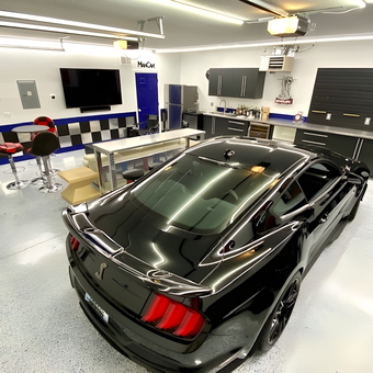 Modern Garage With Cabinets, Bar Stools, and Sports Car - Bruce