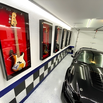 Modern Garage With Display Cases, Checkered Wall, and Sports Car - Bruce