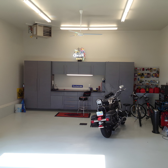Modern garage with cabinets, motorcycles, and tools - Dan from Fargo, ND