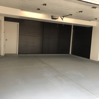 Modern garage with black slatwall panels and gray floor - Tony from Chicago, IL
