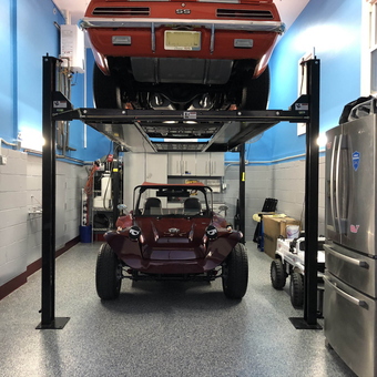 Two-post car lift with classic cars in organized garage - Doug from NJ