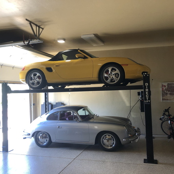 Home garage with car lift and classic cars - Rhonda