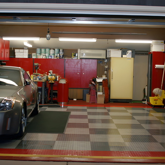 Organized garage with floor tiles, cabinets, and Nissan - Marty from Elkhart, IN