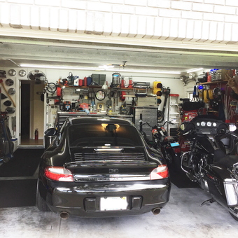 Organized garage with Porsche, motorcycles, and tool storage - Max from Edgewater, FL