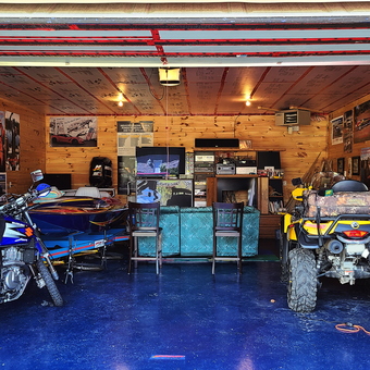 Motorcycle, ATV, and Boat in Wood Paneled Garage - PUD from Petawawa