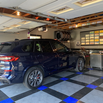 Organized garage with BMW, license plates, and cabinets - Andy from Manassas, VA