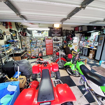 Organized garage with motorcycles, tool chests, and wall storage - Flawless Finish Mobile Detailing from San Diego, CA