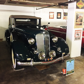 Classic car display with vintage signs in garage - Jack from Bethesda, MD