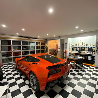 Modern garage with orange sports car and checkered floor - Ed from Summerville, SC