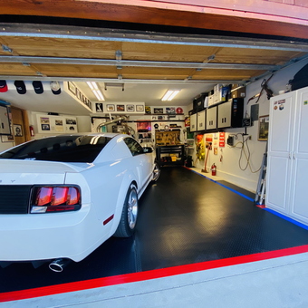 Organized garage with cabinets, tool storage, and car display - Salty Dog from Pine Mountain Club, CA