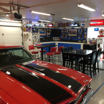 Classic Car Garage with Neon Signs and Bar Stools - Mark