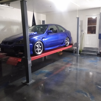 Custom Blue Car on Four Post Lift in Polished Garage - Jay Tuned from Maple park, IL
