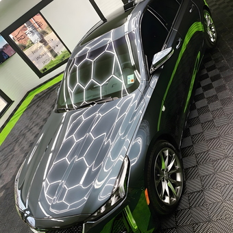 Sleek Car on Black and Green Garage Floor Tiles - Superior Tint Works from New Iberia, LA