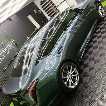 Modern garage with checkered flooring and car - Superior Tint Works from New Iberia, LA