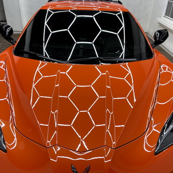 Hexagonal LED Garage Lighting Reflected on Orange Sports Car - Lenny