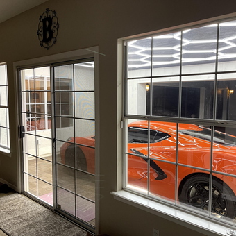 Modern garage with LED lighting and orange sports car - Lenny
