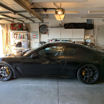 Organized garage with black sports car and storage shelves - Felix from Tracy, CA