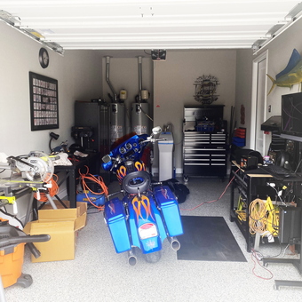 Organized garage with motorcycle, workbenches, and tool storage - Mike from San Antonio, TX