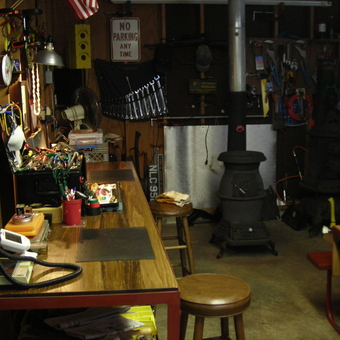 Organized garage workbench with tools and wood stove - john from SANDY LAKE, PA