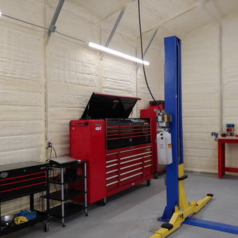 Organized garage with toolboxes, lift, and workbench - Sharp from Temple, TX