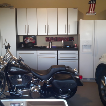 Modern garage with cabinets, motorcycle, and fridge - Tom from Waconia, MN