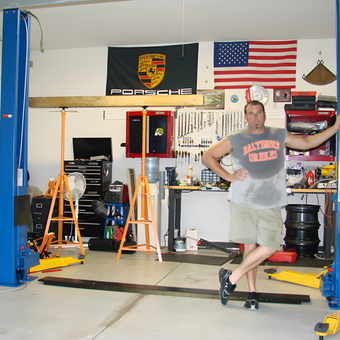 Organized Garage With Car Lift, Tool Storage, and Workbench - D Walsh