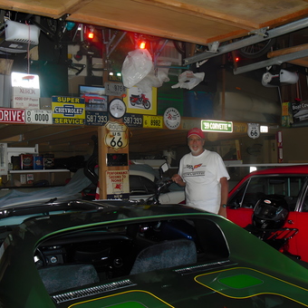 Classic cars and Corvette signs in packed garage - Thom from Kirkland, WA