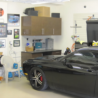 Organized garage with wall storage, cabinets, and car - Mark from Brookville, NY