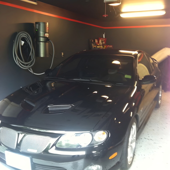 Clean garage with wall-mounted vacuum and black car - Cheryl from Shelton, CT