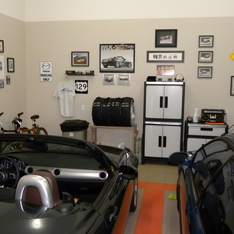 Organized garage with cabinets, wall art, and cars - Dennis from Thunder Bay, Ontario