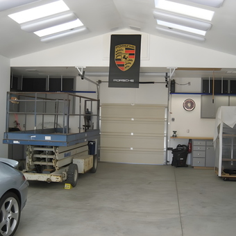 Organized garage with cabinets, workbenches, and Porsche decor - Keith from Santa Maria, CA