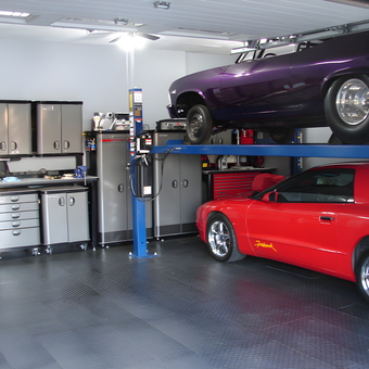 Organized garage with car lift, cabinets, and tool chests - John from Saskatchewan, Canada